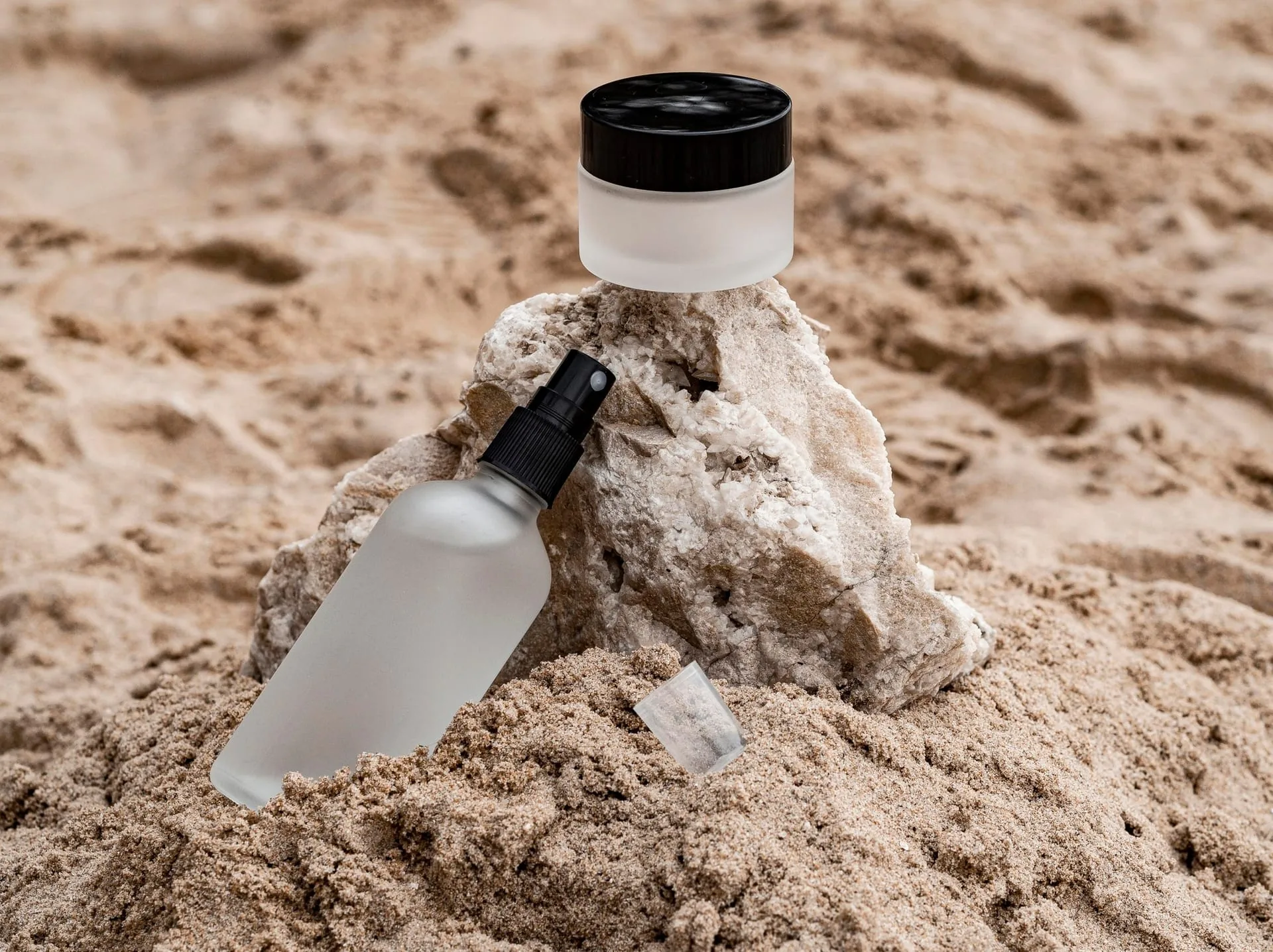 A full coastal skincare ritual laid out on a soft surface at dusk
